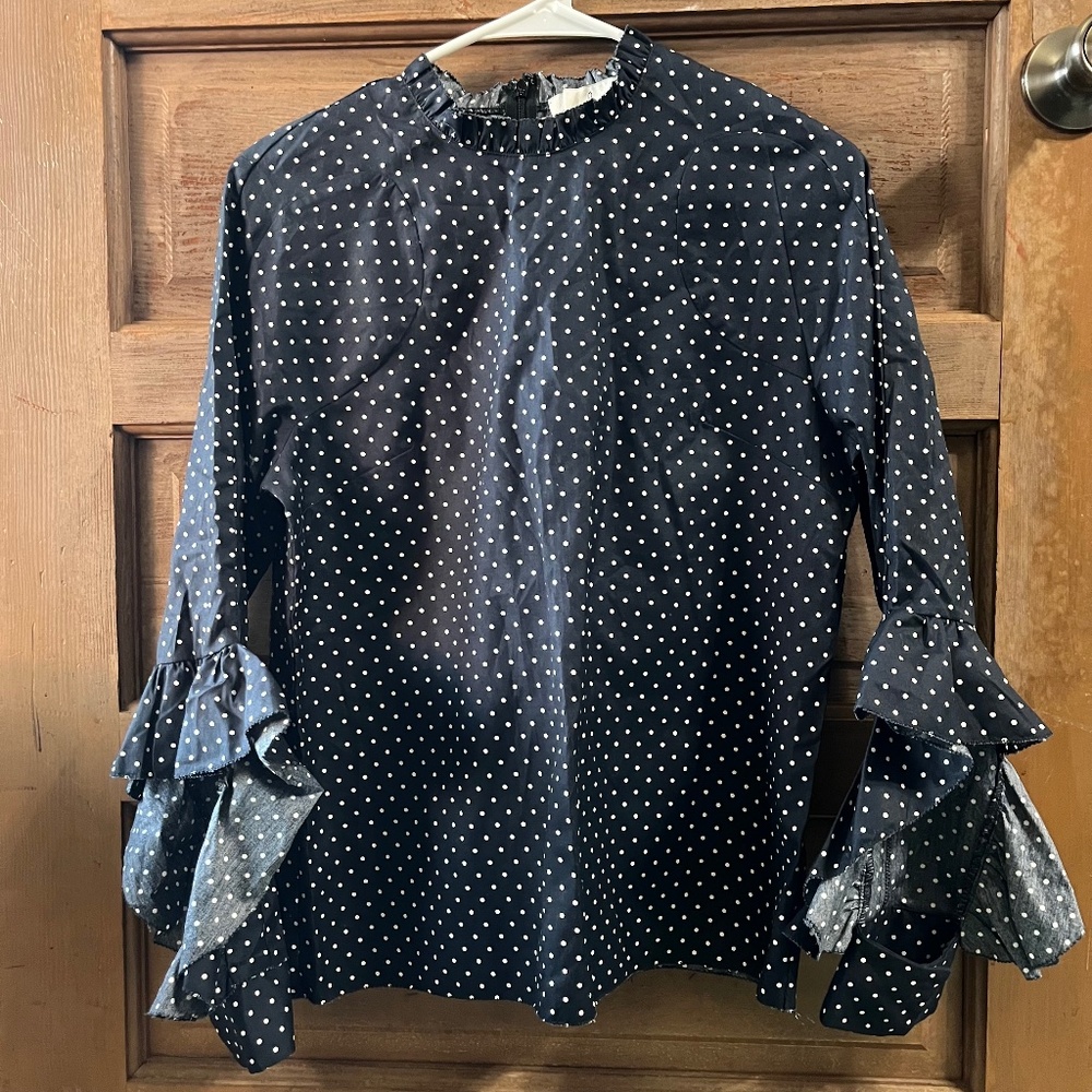 www.aalis.hk a ruffle collar, a zipped back closure, and a gathered neckline.